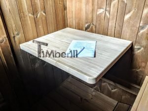 TimberIN Nordic Oval™ Terrace – interior: mesita abatible de pared en madera clara junto al banco de listones