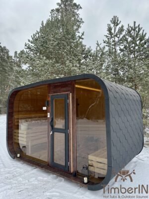 Sauna de jardín Nordic Horizon con vestidor, vista de tres cuartos en la nieve